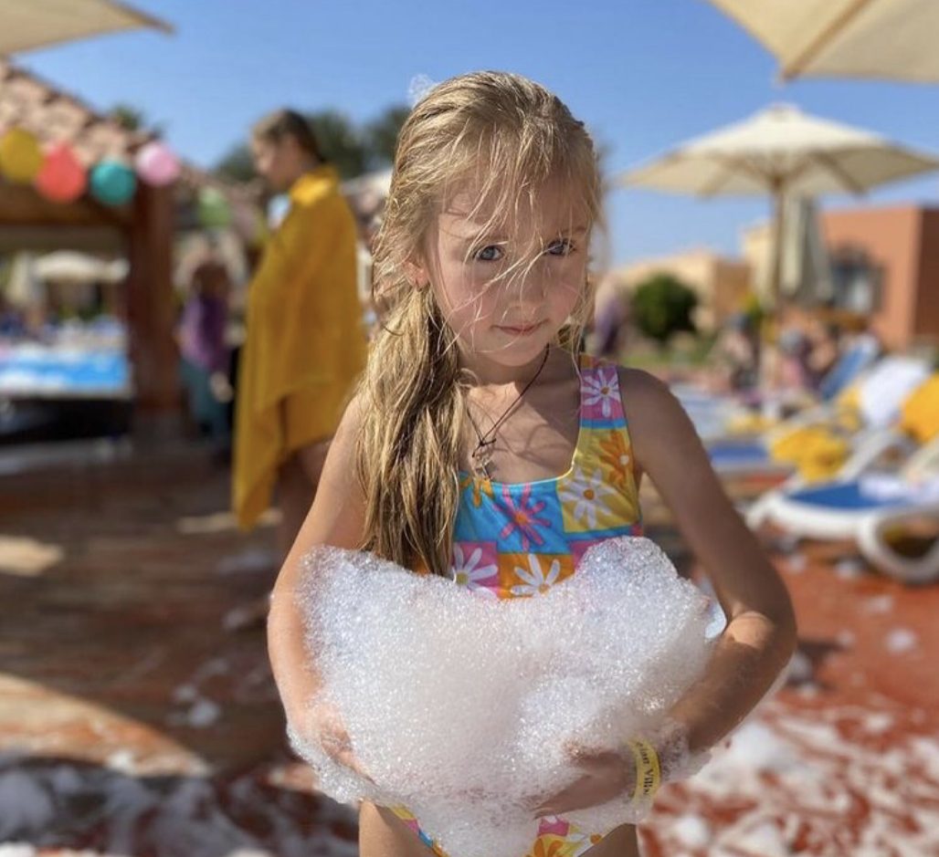 Girl holding a handful of foam close to the camera