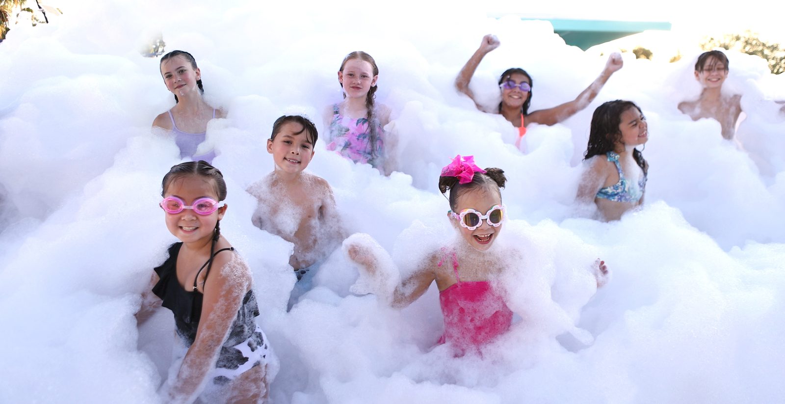 Group of kids wearing goggles playing in deep foam